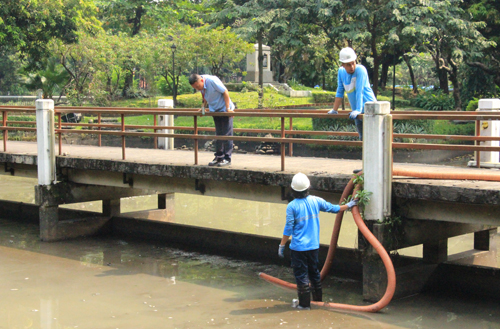 泥の吸い出しを行う作業員ら=17日午前11時ごろ、首都圏マニラ市で森永亨撮影