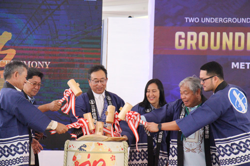 鏡開きするバウティスタ運輸相(右から2人目)、ケソン市ベルモンテ市長(同3人目)、JICA坂本威午所長(同4人目)、山地斉常務執行役員(左端)=ケソン市アギナルド基地内で13日、沼田康平撮影